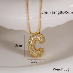 Detailed view of gold C-letter pendant with zircon inlay showing 45cm chain length