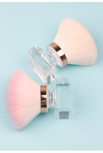 Macro detail of large makeup brushes with transparent handles and soft colorful bristles