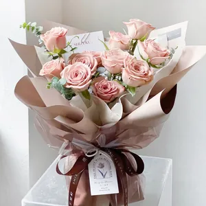 Elegant champagne rose bouquet in pink and brown paper with minimalist Shizuku Flora tag