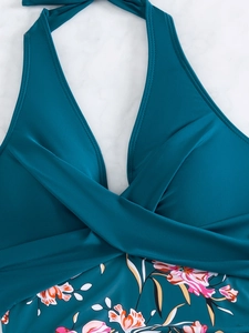 Detail of teal halter neck bikini top with criss-cross pleated design and floral print