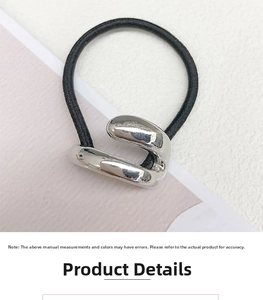 Detail showing high-elastic black hair tie with minimalist silver geometric metal buckle