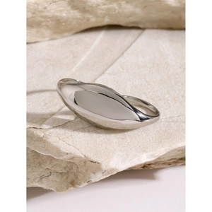Macro view of minimalist chunky silver polished ring on natural textured stone base