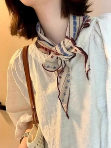 Detail of vintage striped neck scarf in beige and blue cotton-linen with soft floral print