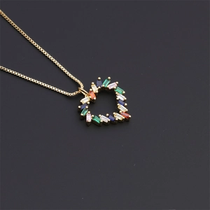 Close-up of gold-plated heart pendant necklace with multi-colored rectangular zircon stones