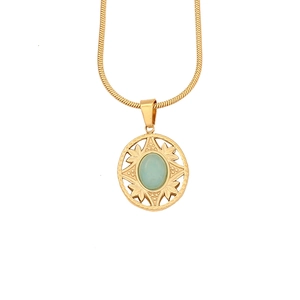 Detail of vintage round pendant necklace featuring green natural stone and sun pattern