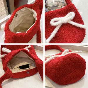 Red plush bucket bag with white bow detail and magnetic closure for casual style