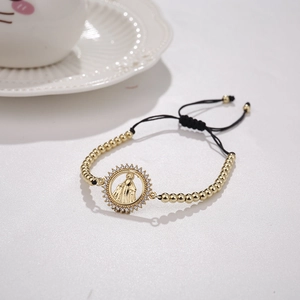 Detail of gold-plated Virgin Mary charm bracelet with micro-paved white zircons