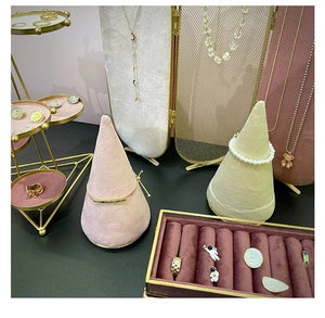 Detail showing jewelry display set with astronaut earrings, pearl bracelets and gold rings