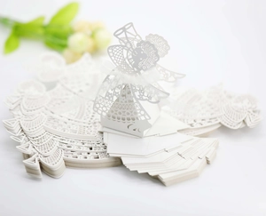 Laser-cut white paper wedding favor box featuring an angel design and white ribbon