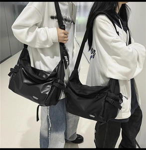 Close-up of black street-style crossbody bags in PU and nylon with detachable AVR coin pouch