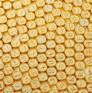 Macro view of gold acrylic alphabet beads for DIY handmade jewelry crafting