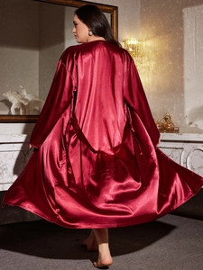 Macro detail of wine red satin bathrobe with luxury silk texture and adjustable waist tie