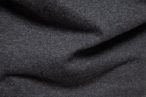 Macro shot of dark grey soft cotton knit fabric texture with high density fibers