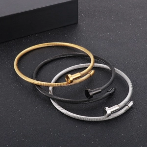 Three stainless steel nail bracelets in gold, black and silver with steel wire rope texture