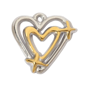 Macro shot of silver and gold heart-shaped pendant with intricate hollow star details