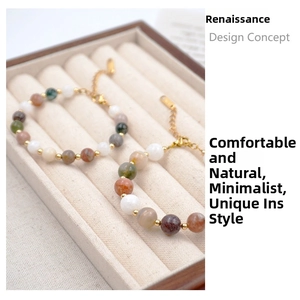 Detailed macro view of multi-colored natural stone beaded bracelets with golden spacer beads