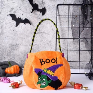 Close-up of orange plush Halloween candy bag with green witch embroidery and Boo lettering