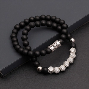 Detail of matte black beaded bracelets with cubic zirconia crown and disco balls