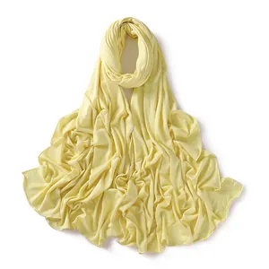Detail of soft jersey cotton scarf in bright yellow with fine stitched edge finish