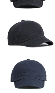 Macro view of washed cotton short brim baseball cap showing 6-panel structure and stitching