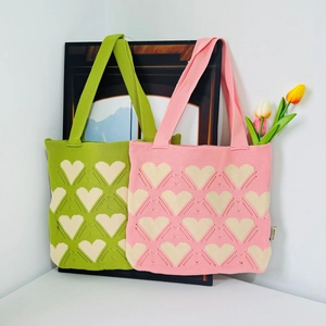 Knitted tote bag with heart pattern in green and pink colors, stylish shoulder bag