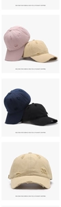Detailed view of distressed washed cotton baseball caps with vintage ripped fabric texture