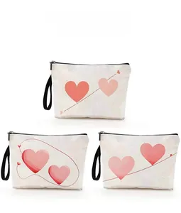 Three canvas cosmetic bags with pink heart patterns and black zippers for Valentines Day