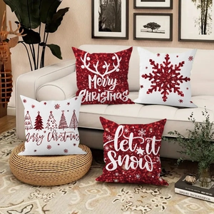 Detailed view of red and white Christmas pillow covers with reindeer and snowflake patterns