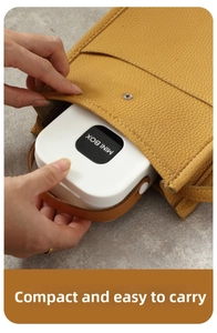 Putting the white portable MINI BOX organizer into a yellow leather bag for travel use