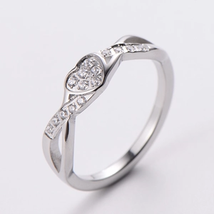 Detail of silver infinity heart ring featuring a crisscross band with pavé set diamonds