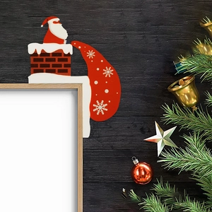 Detail of wooden Santa Claus on chimney corner decor with gift bag and festive greenery