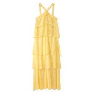 Detailed view of yellow tiered chiffon maxi dress with 3D floral accent on halter neck