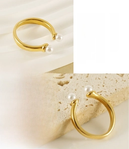 Detailed view of 18K gold plated stainless steel ring with elegant white pearls