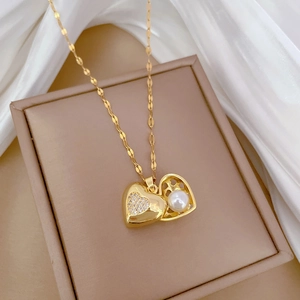 Luxurious titanium steel necklace with heart pendant, pearls, and diamonds on a silk background