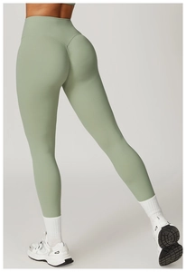 Detail view of high-waist sage green yoga pants featuring V-shaped seam for butt-lifting