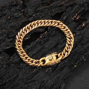 Close-up of golden dual-weave Cuban chain with dragon clasp on textured dark wood