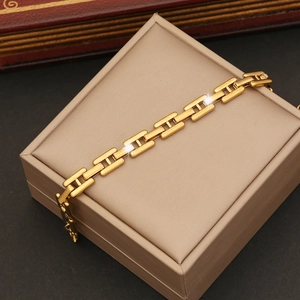 Macro view of golden pig nose link bracelet displayed on a luxury jewelry box