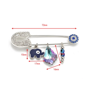 Detail of silver brooch pin with blue evil eye, elephant charm and size measurements