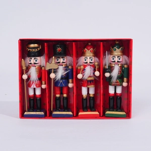Close-up of four wooden nutcracker soldier ornaments in a red gift box display