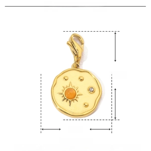 Detailed view of a gold sun pendant featuring orange natural stone and tiny rhinestones