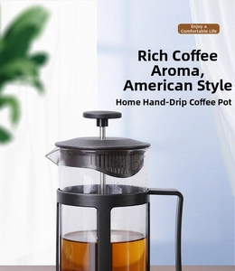 Detail of French press coffee maker featuring heat-resistant glass and black handle
