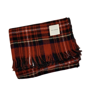 Classic red and black plaid scarf with fringe edges and a white brand label