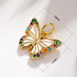 Detailed macro view showing a 13mm x 11mm gold butterfly pendant with colorful gemstones