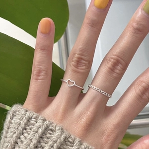 Detail of 925 sterling silver heart rings set worn together for a minimalist look
