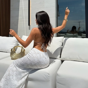 Elegant white lace vest and high waist maxi skirt set with metallic gold handbag