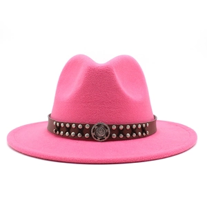 Detailed shot of hot pink wide brim fedora with studded leather band and vintage buckle