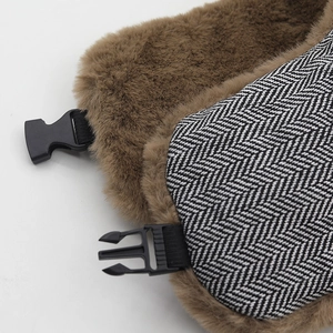 Close-up of winter trapper hat showing herringbone wool and brown faux fur lining