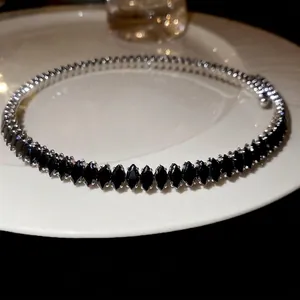 Marquise-cut black zircon choker necklace with silver-tone base on a white ceramic tray
