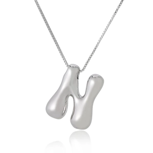 Detailed close-up of a 3D puffy silver letter N pendant with a venetian box chain