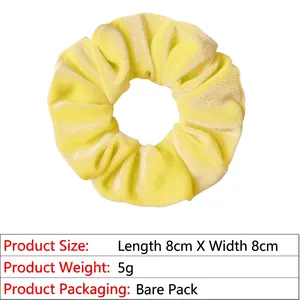 Detail of yellow velvet scrunchie showing 8cm diameter and soft elastic fabric texture